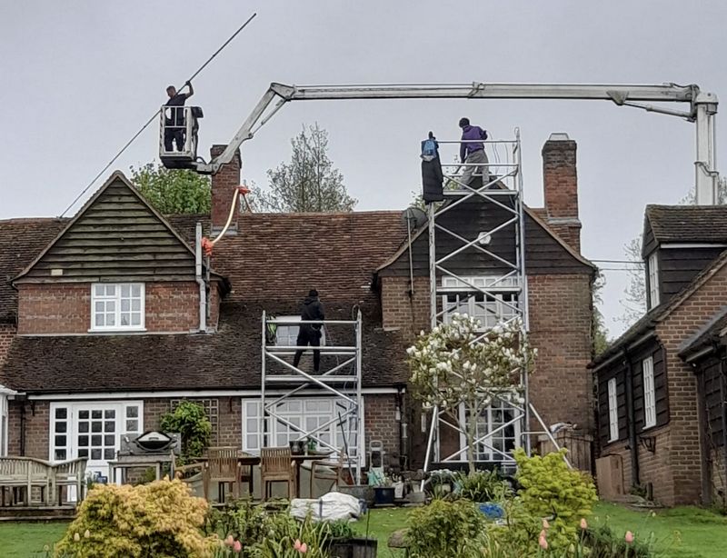 The Roof Moss Cleaners using cherry picker and scaffolding to clean roof safely and professionally in Burghfield Common, Berkshire
