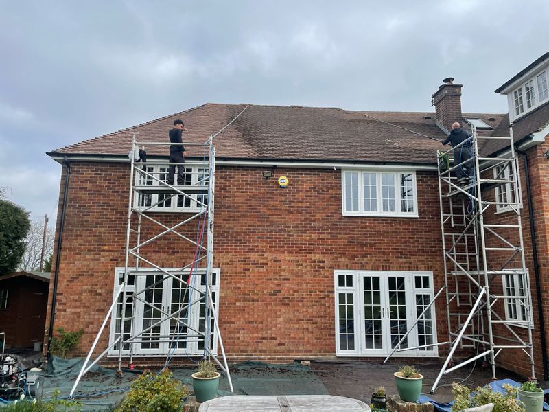 Roof cleaning carried out safely from scaffold towers by The Roof Moss Cleaners in Burghfield Common
